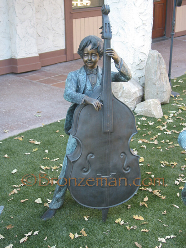 bronze statue of children playing instruments