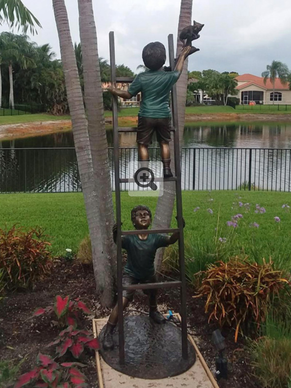 bronze statue of boys on a ladder
