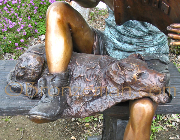bronze statue of a girl reading with a dog