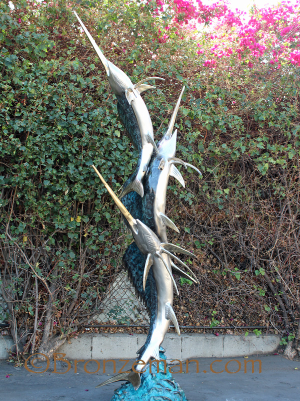 bronze statue of three sailfish
