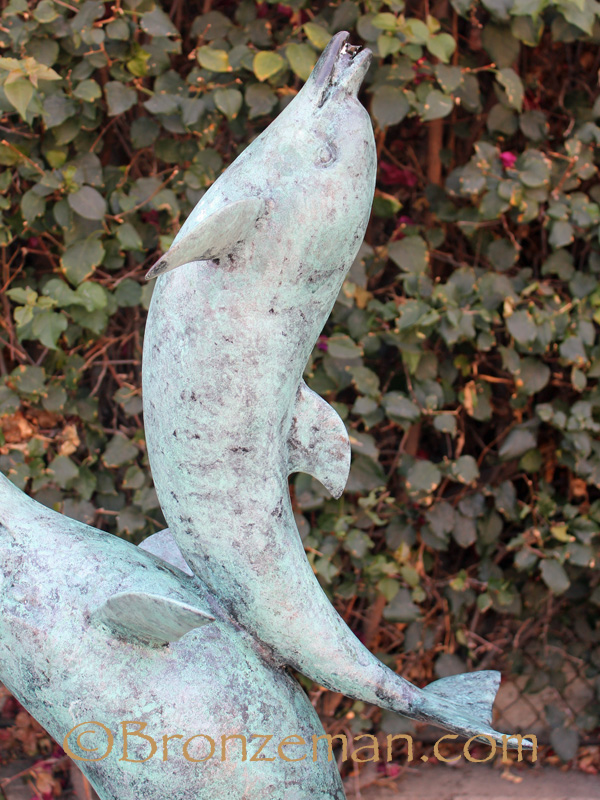 bronze statue of two dolphins