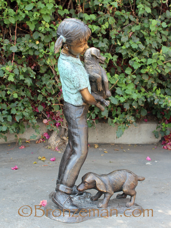 bronze statue of girl with dogs