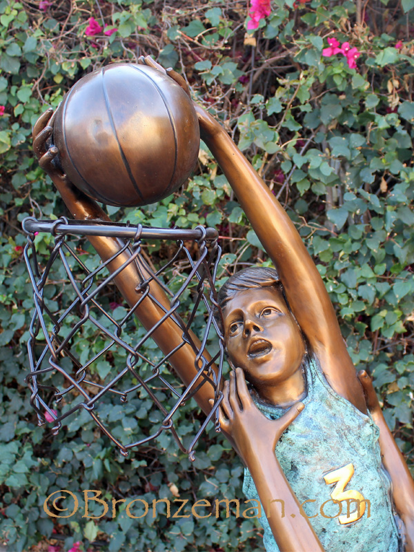 bronze sculpture of children playing basketball