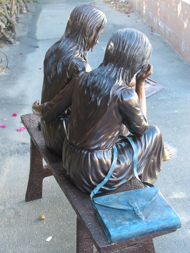 bronze statue of girls reading