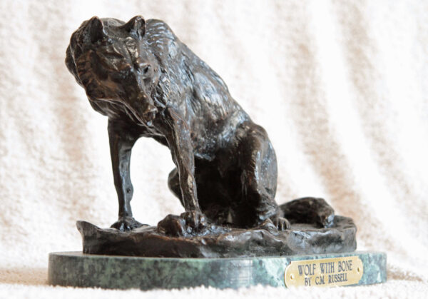 bronze wolf with bone statue