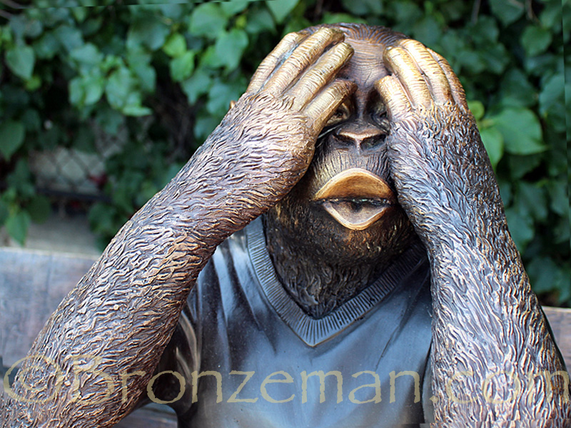 bronze monkeys on a bench statue