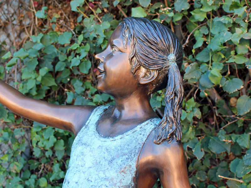 bronze statue of girl holding shell