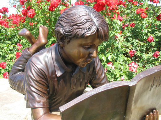 bronze statue of a boy reading