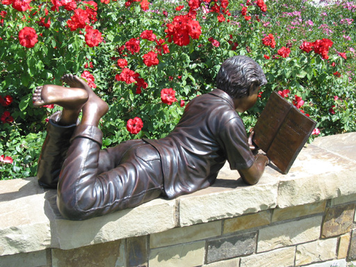 bronze statue of a boy reading