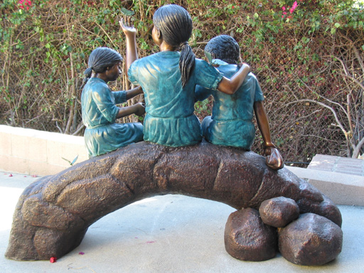 bronze statue of children with butterflies