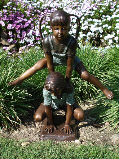 bronze statue of children playing leap frog