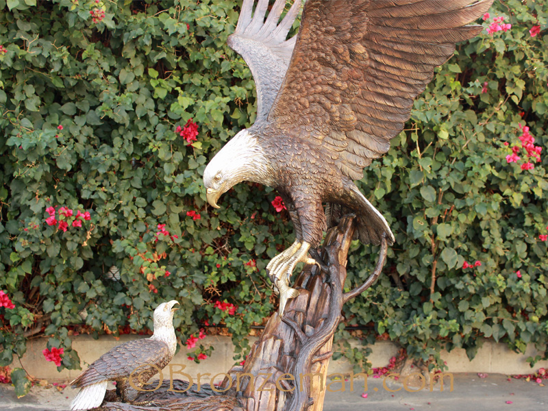 bronze statue of eagle feeding baby