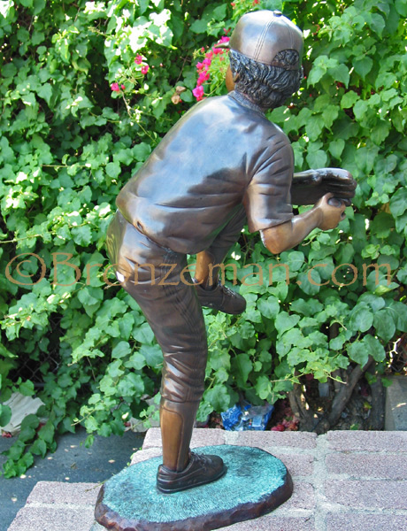 bronze statue of a boy baseball pitcher