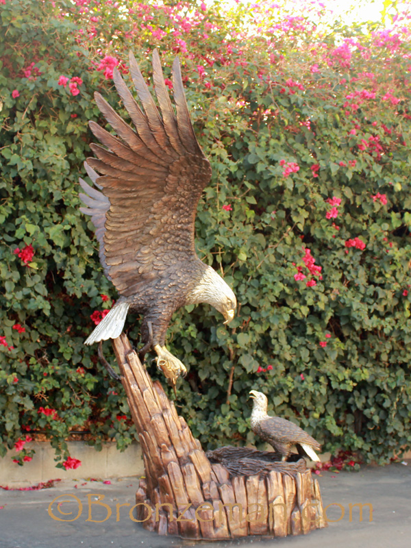 bronze statue of eagle feeding baby