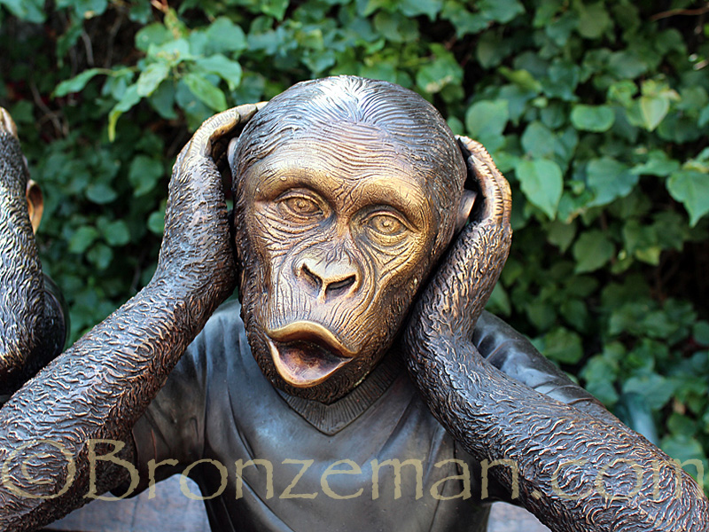 bronze monkeys on a bench statue
