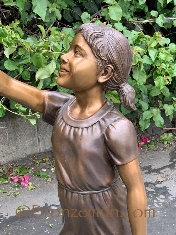 bronze statue of boy and girl with flag