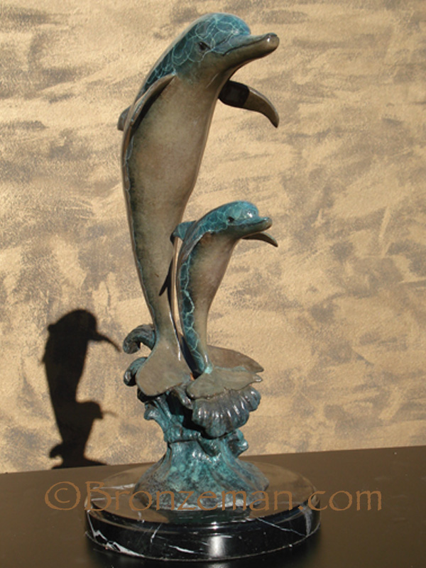 bronze statue of 2 dolphins