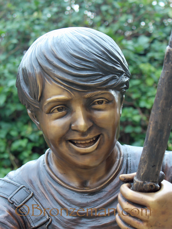 bronze statue of a boy fishing
