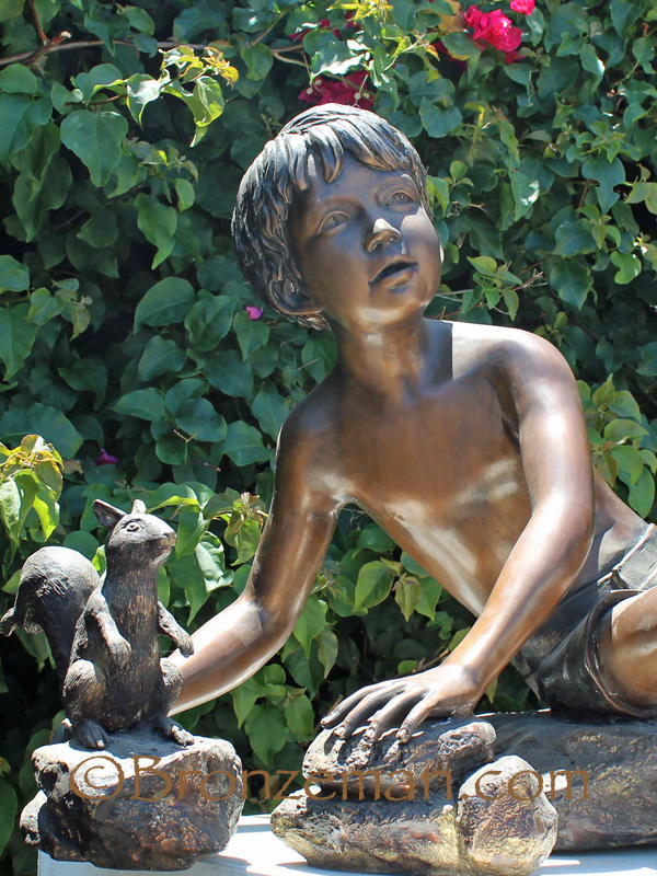 bronze statue of a boy and squirrel