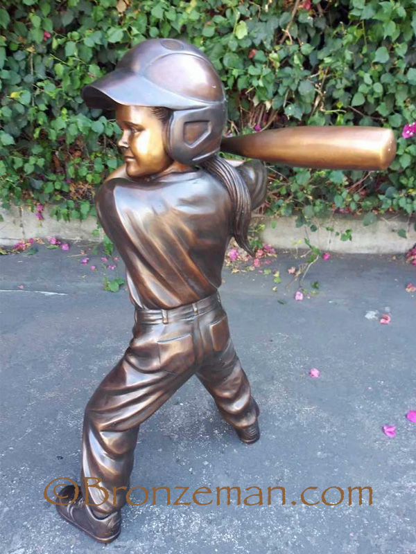 bronze statue girl playing softball