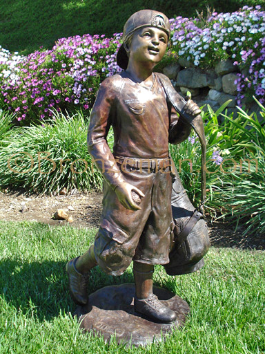 bronze statue of a boy golfing