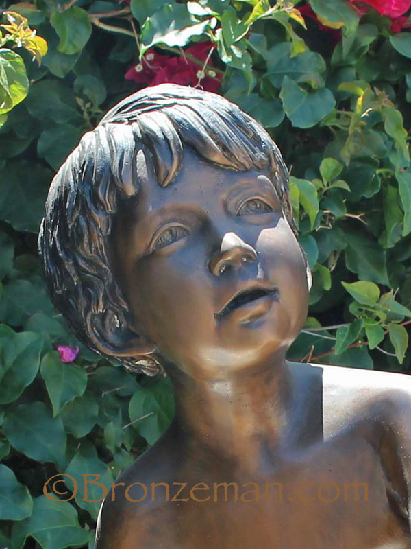 bronze statue of a boy and squirrel
