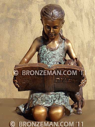 bronze statue of a girl reading