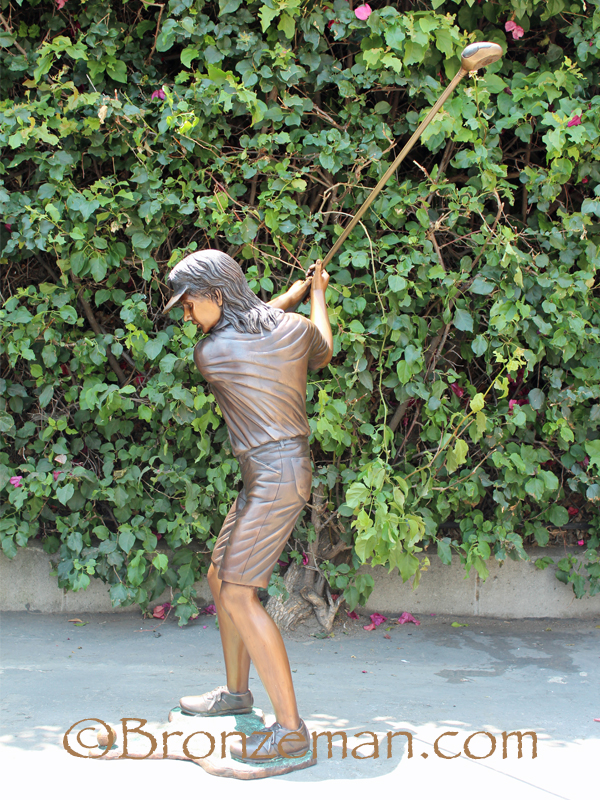 bronze statue of a girl golfer