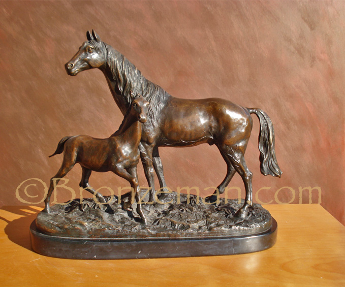 bronze horse statue of a mare and foal