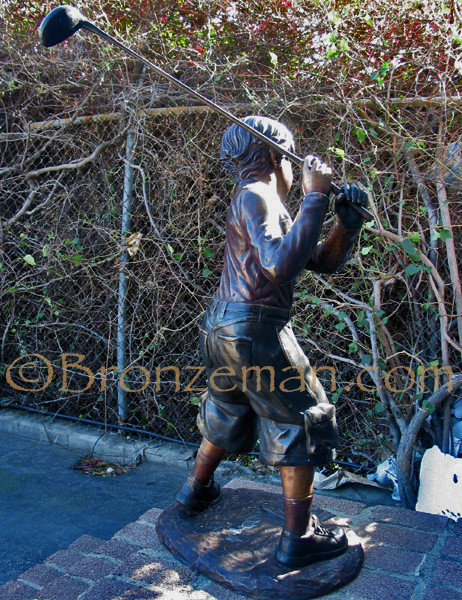 bronze statue of a boy golfer