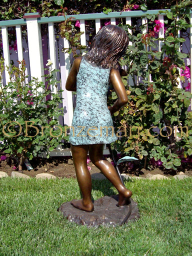 bronze statue of a girl with flower