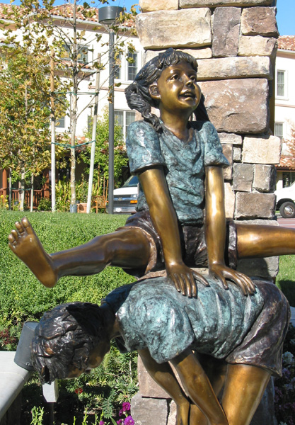 bronze statue of kids playing leap frog