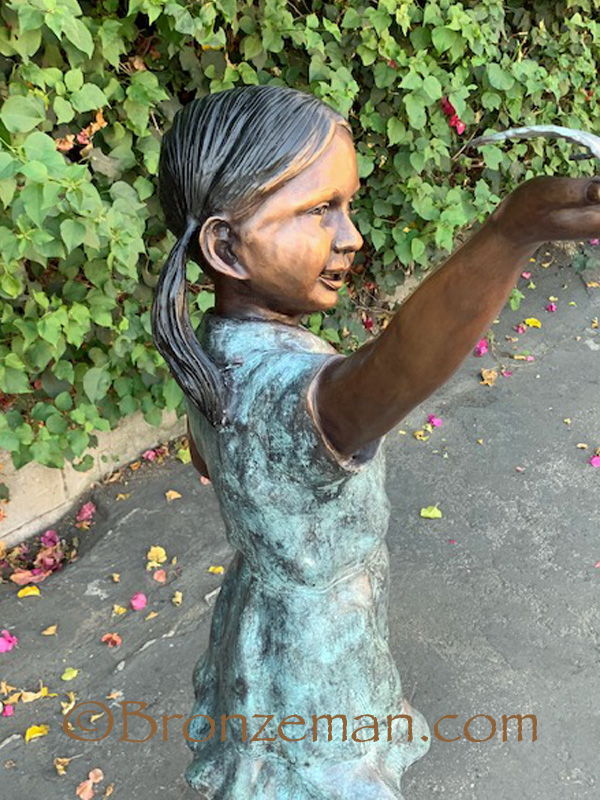 bronze statue of a girl with butterfly