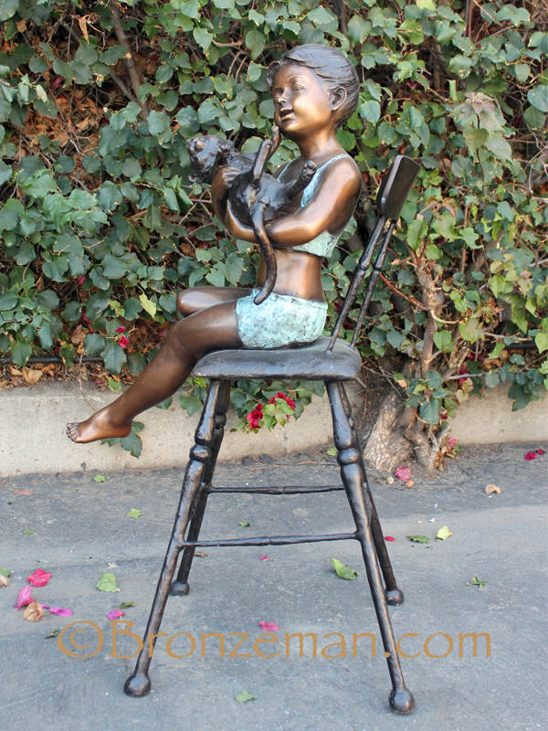 bronze statue of a girl with cat