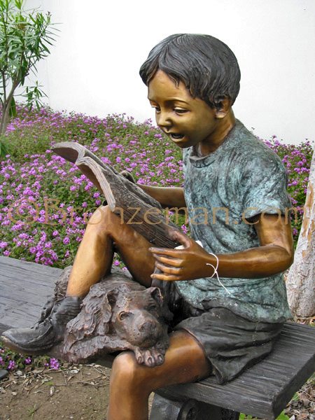 bronze statue of a girl reading with a dog