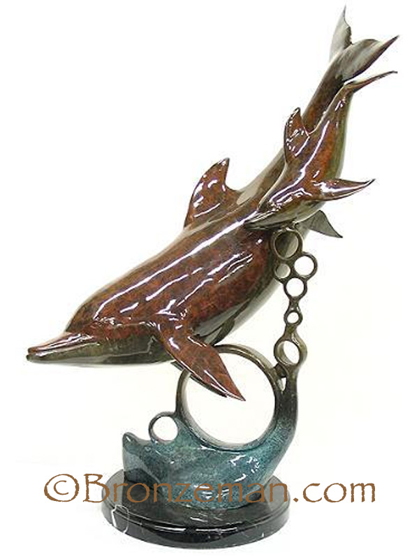 bronze statue of dolphins swimming