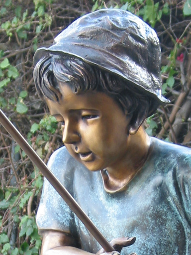 bronze sculpture of boy fishing