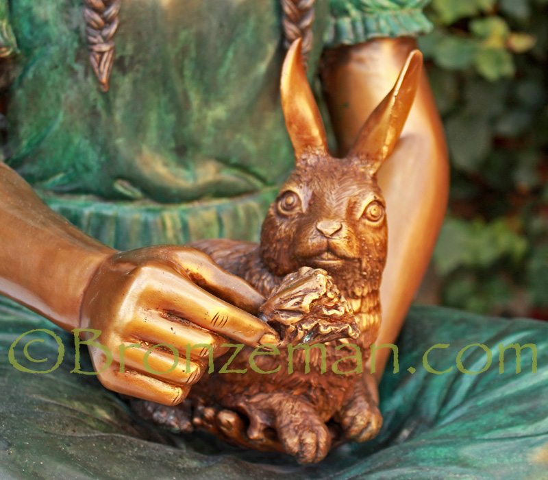 bronze statue of a girl and rabbit