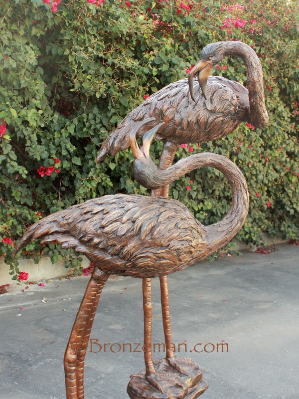 bronze statue of two herons