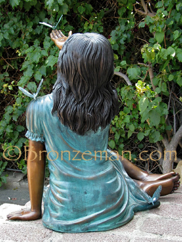 bronze statue of a girl with butterflies