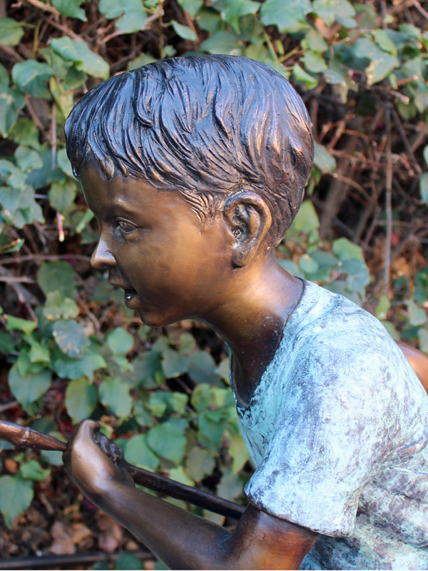 bronze statue of boy fishing