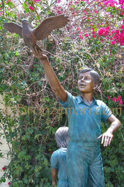 bronze statue of children climbing a rock