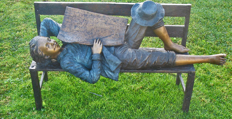 bronze statue of child taking a nap