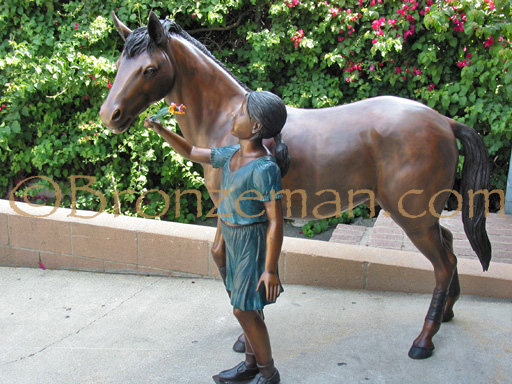 bronze statue of girl with horse