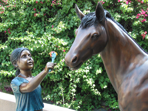 bronze statue of girl with horse