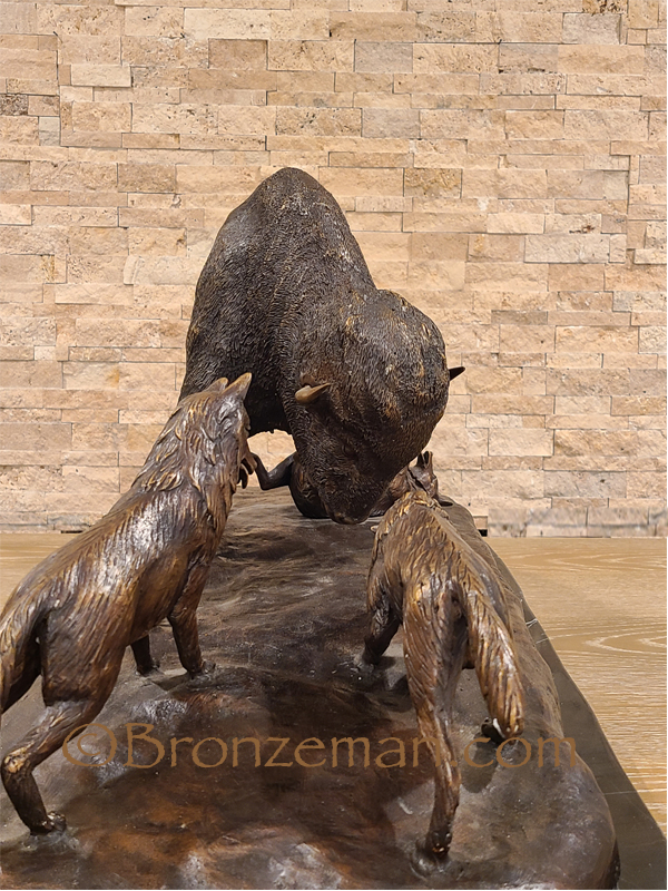 Bronze bison statue with wolves