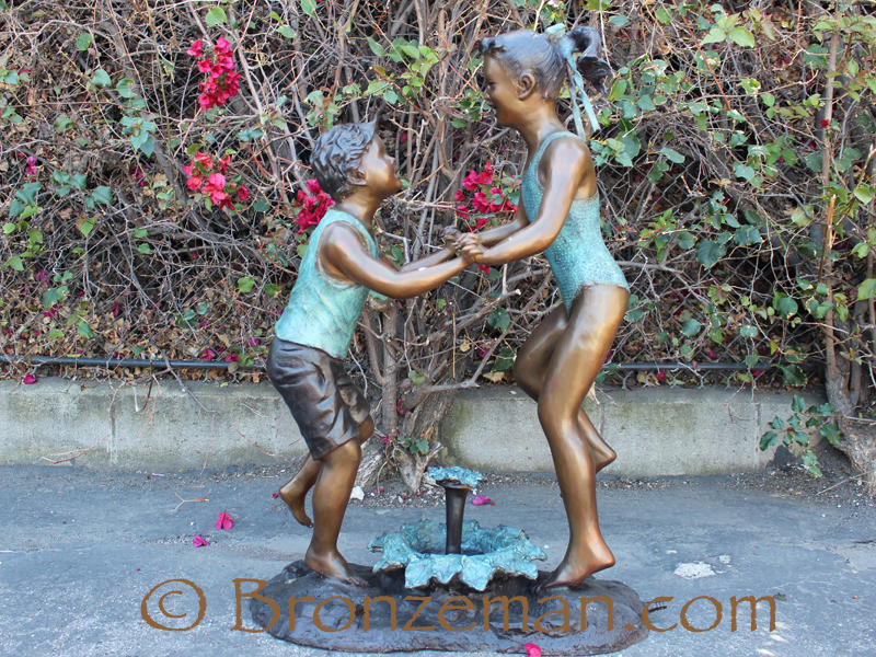 bronze statue of children playing