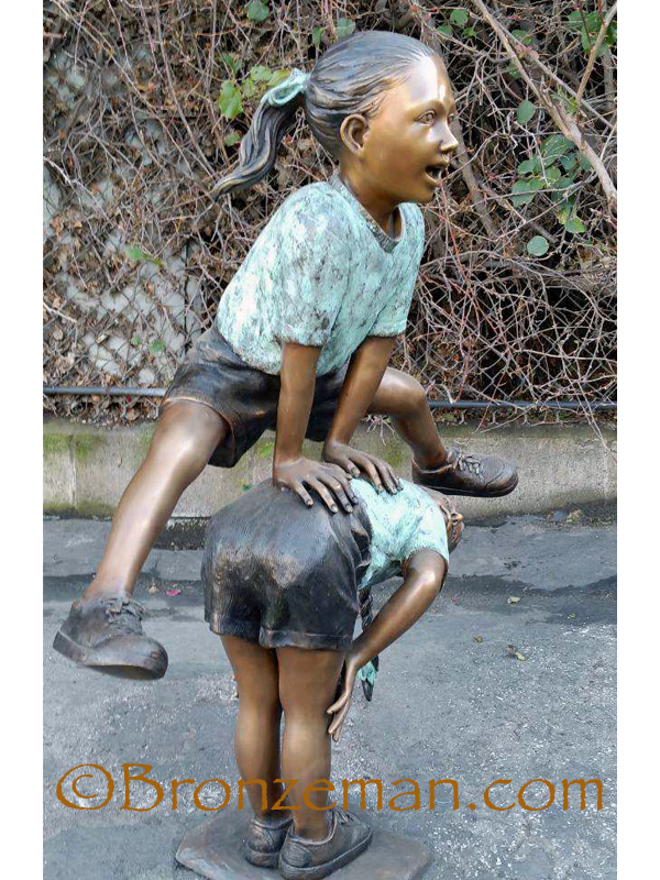 bronze statue of girls playing leap frog