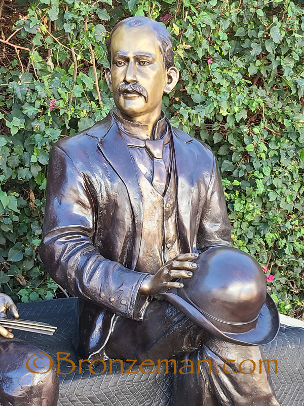 custom bronze statue of man sitting