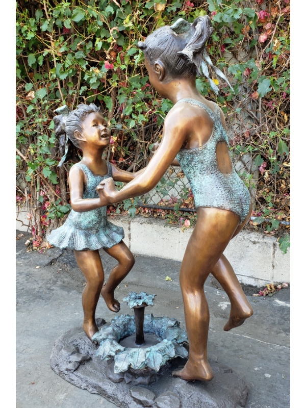 bronze statues of girls dancing